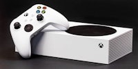 a white xbox controller sitting on top of a white box